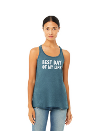 Thumbnail for medium-skinned person with brown hair pulled back wearing a blue tank top with best day of my life written across in white block lettering.