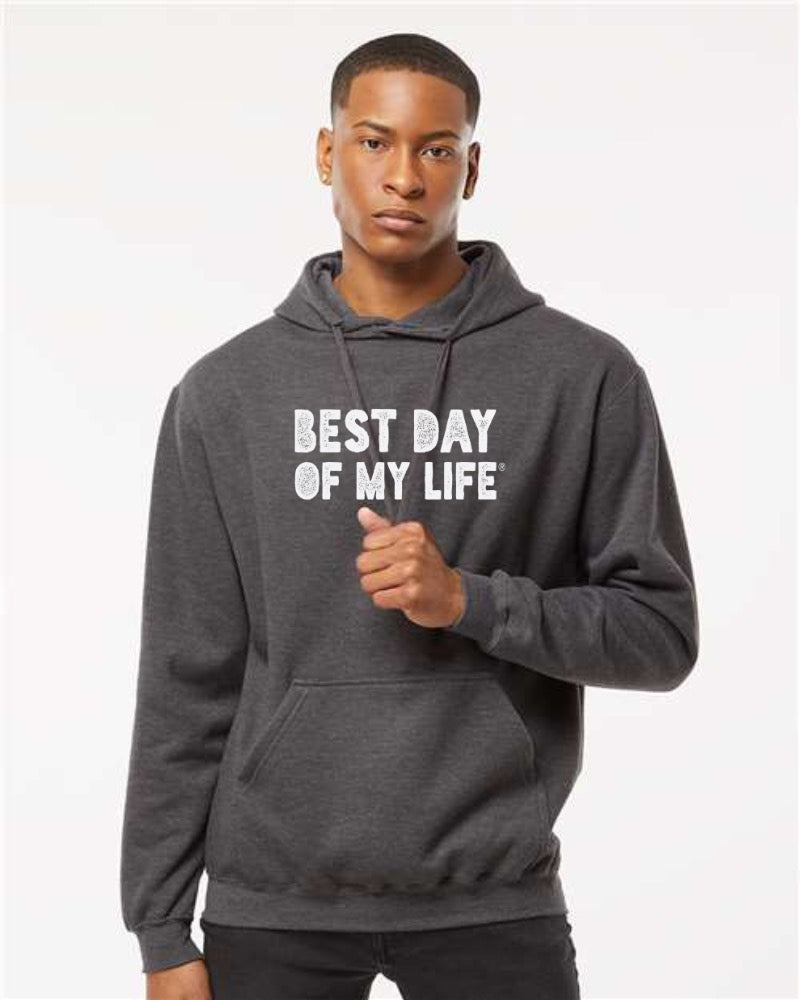 dark-skinned person with short hair wearing a grey pullover hoodie with best day of my life written in white block lettering