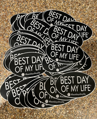 Thumbnail for pile of black oval magnets that read best day of my life with a qr code